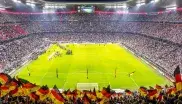 Panorama-Blick auf den Rasen der Allianz Arena, Fans schwenken Deutschland-Fähnchen